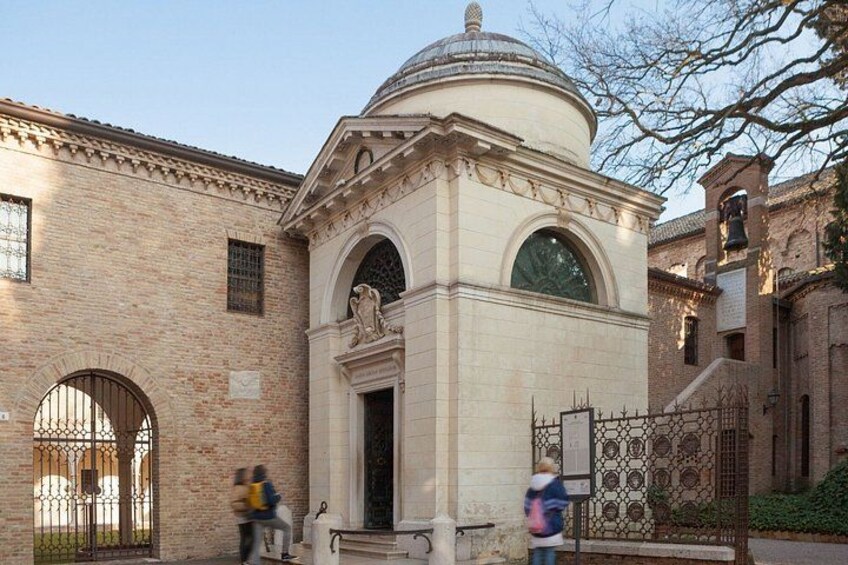 A historic building with a dome, arched windows, and a gate. 3