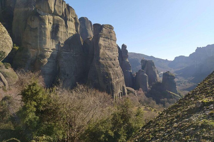 A rocky landscape with prominent rock formations and sparse vegetation. 2