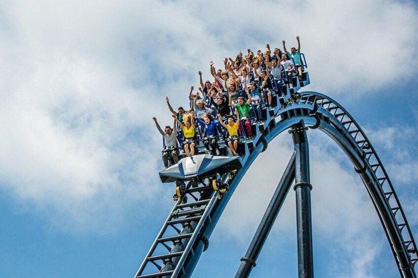 A roller coaster with riders at the peak of the track. 1