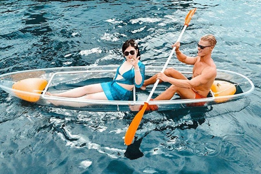 Two people in a transparent boat on water. 2