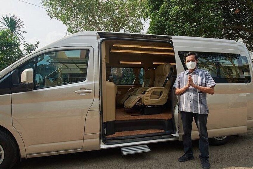 A person standing next to an open van with a beige interior. 4