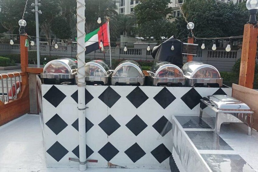 A rooftop with a black and white checkered wall, a flag, and a grill. 3