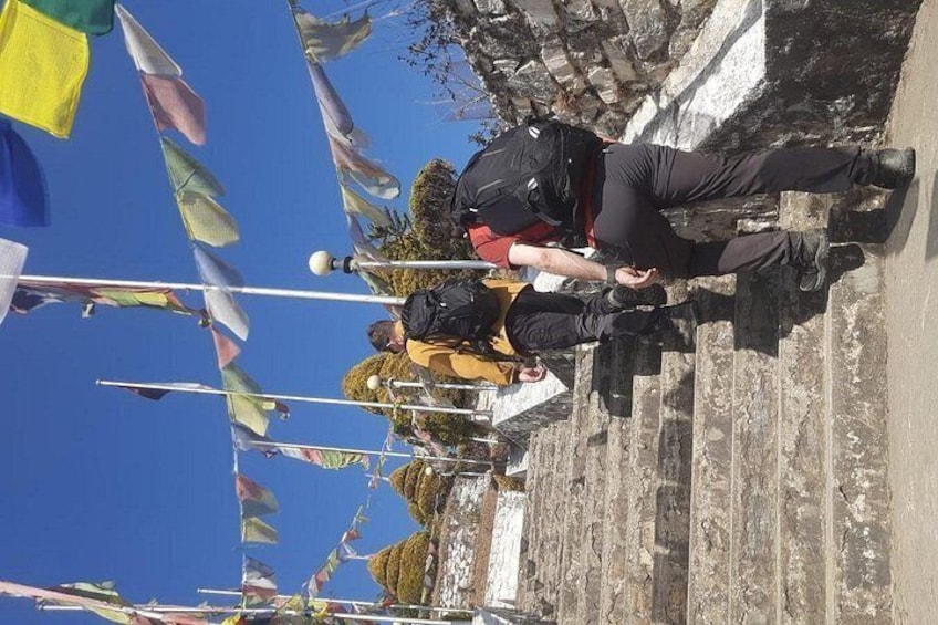 People standing on a stone staircase with flags. 2