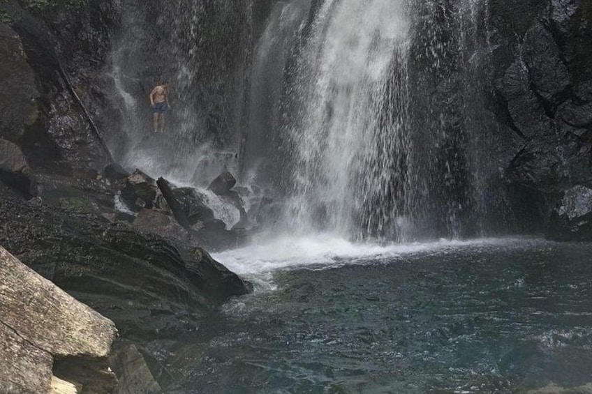 A waterfall cascading into a pool surrounded by rocks. 3