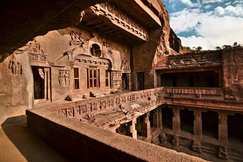 An ancient rock-cut temple with intricate carvings and a multi-tiered structure. 2