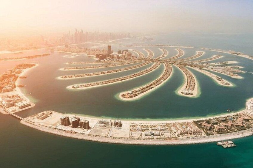 A large body of water with a circular island featuring a distinctive, palm-tree-like structure. 5