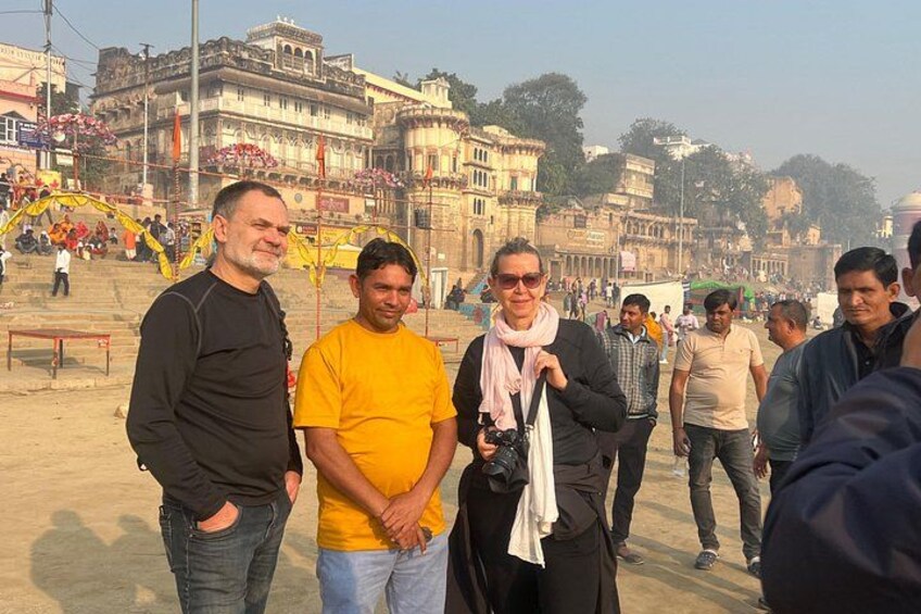A group of people standing on a street with historic buildings in the background. 4