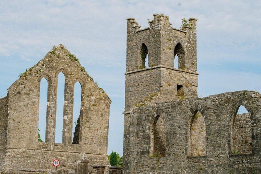 A historic stone structure with arches and a tower. 4