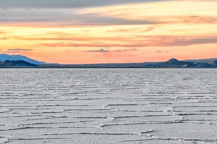 A frozen lake with a sunset in the background. 4