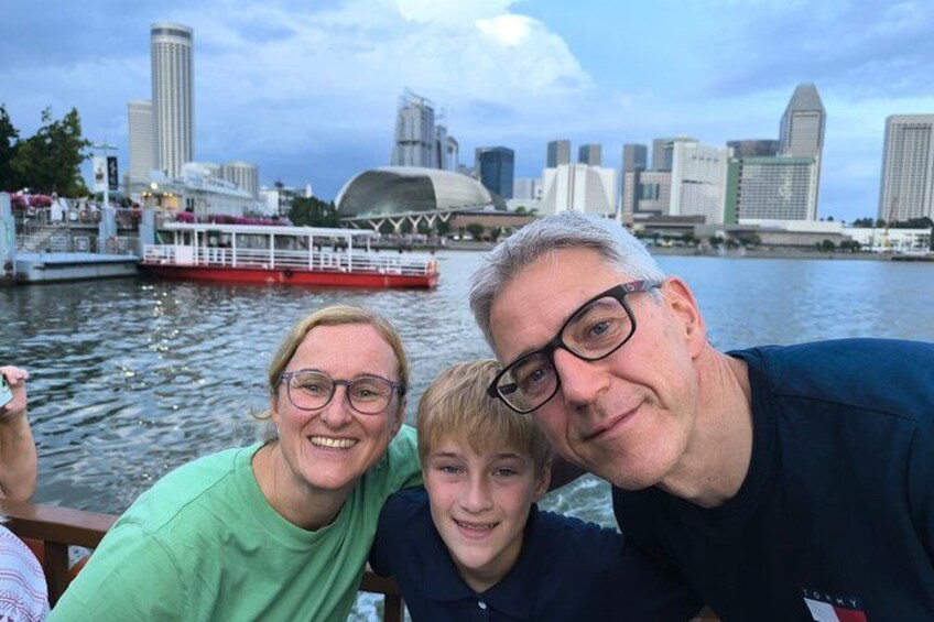 A family on a boat with a city skyline in the background. 2