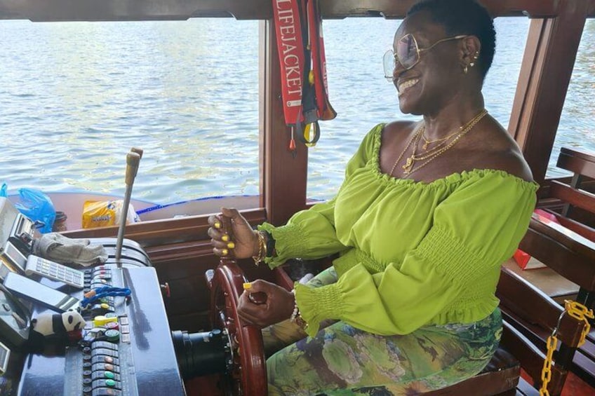 A guest having a fun moment at the helm during the Singapore River Cruise on our night tour. 3