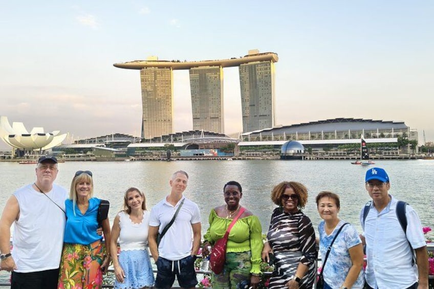 Guests posing by the Marina Bay waterfront with Marina Bay Sands during our Singapore night tour. 5