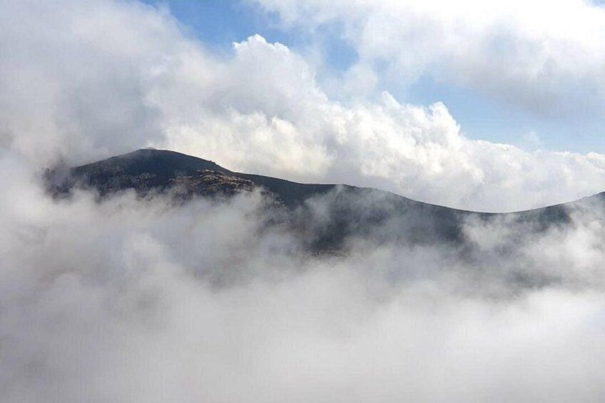 A mountain partially obscured by clouds. 5