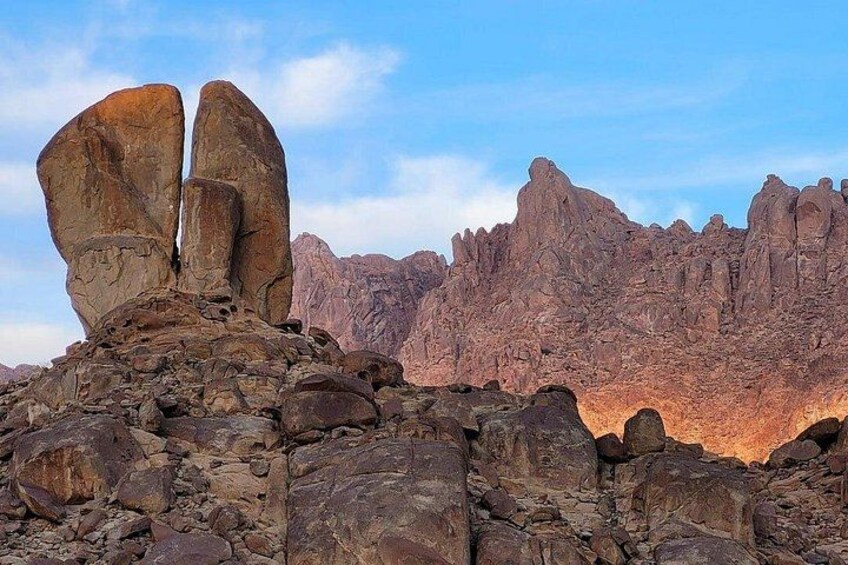 A rocky landscape with prominent rock formations and a clear sky. 2