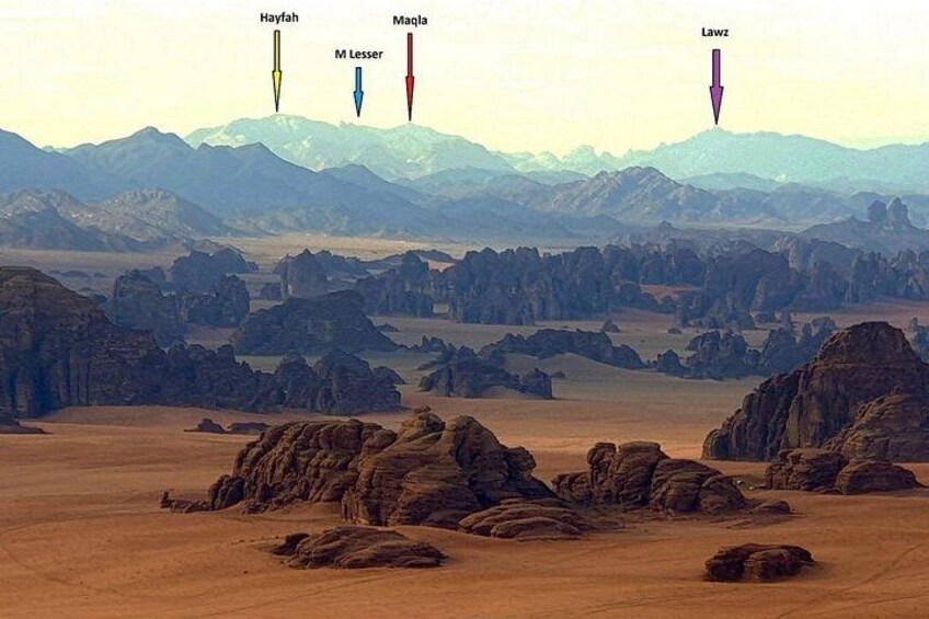A desert landscape with rocky formations and distant mountains. 4