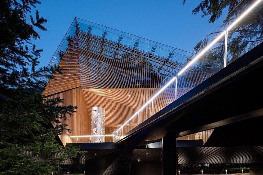 A modern building with a wooden facade and a glass structure. 5