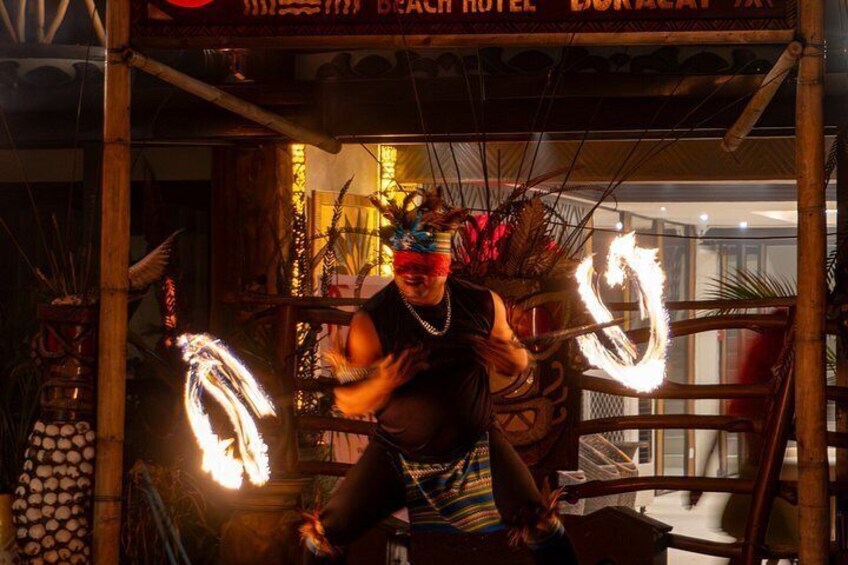 A performer with a fire poi in a traditional costume. 2