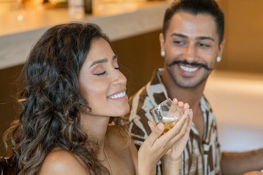 A person holding a small glass. 1