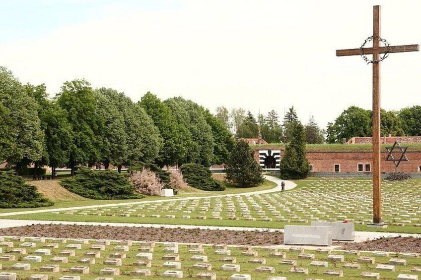 A cemetery with gravestones, a wooden cross, and a Star of David. 4