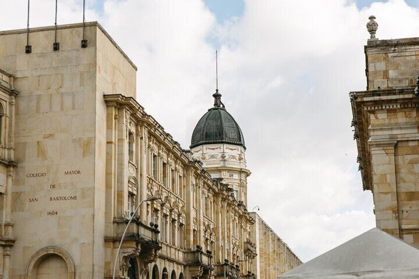 A historic building with a dome and inscriptions on its facade. 1