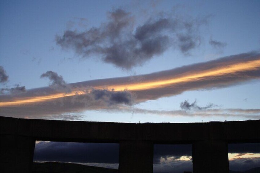 A bridge with a sunset sky. 1