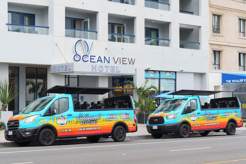 Two colorful tour buses parked in front of the Ocean View Hotel. 3