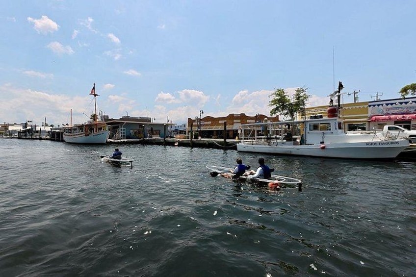 A harbor with boats, a dock, and buildings in the background. 3