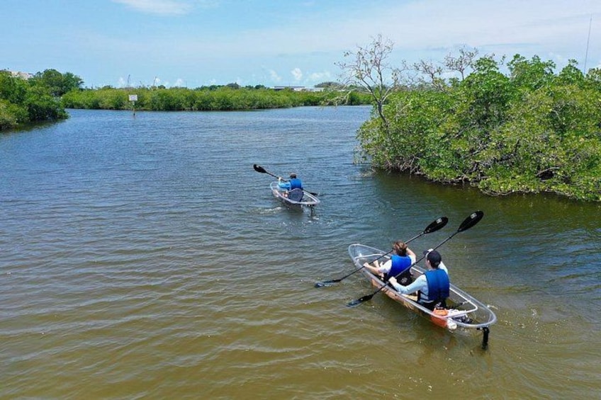 Two kayaks on a calm river surrounded by greenery. 3