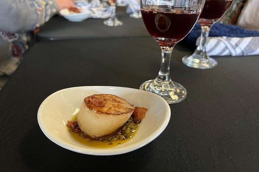 A dessert on a plate with a glass of red wine in the background. 4