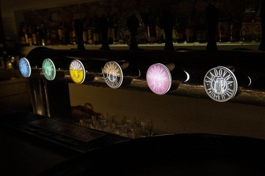 A bar with illuminated beer taps. 3
