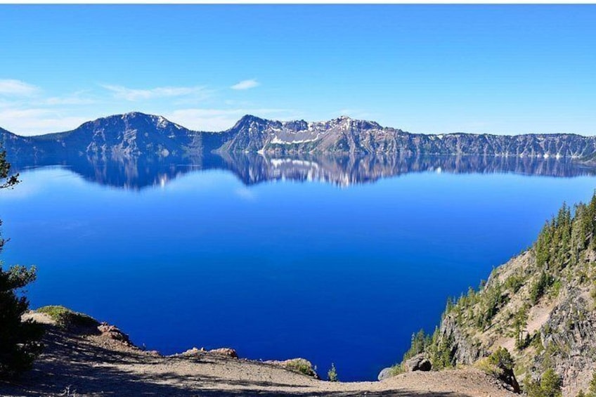 A calm lake surrounded by mountains. 4