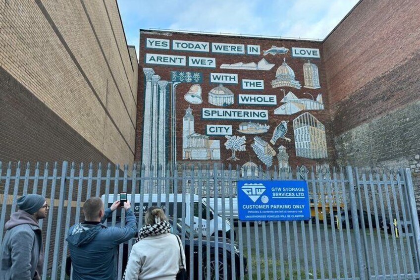 A mural on a brick wall with a sign for GTW Storage Services Ltd. 1