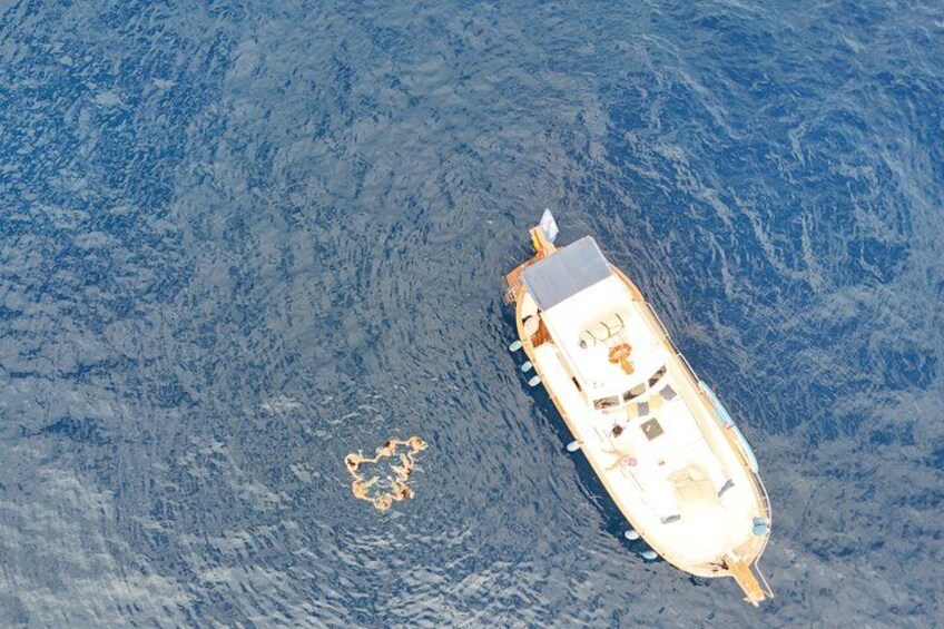 A boat on calm water with a small island nearby. 3