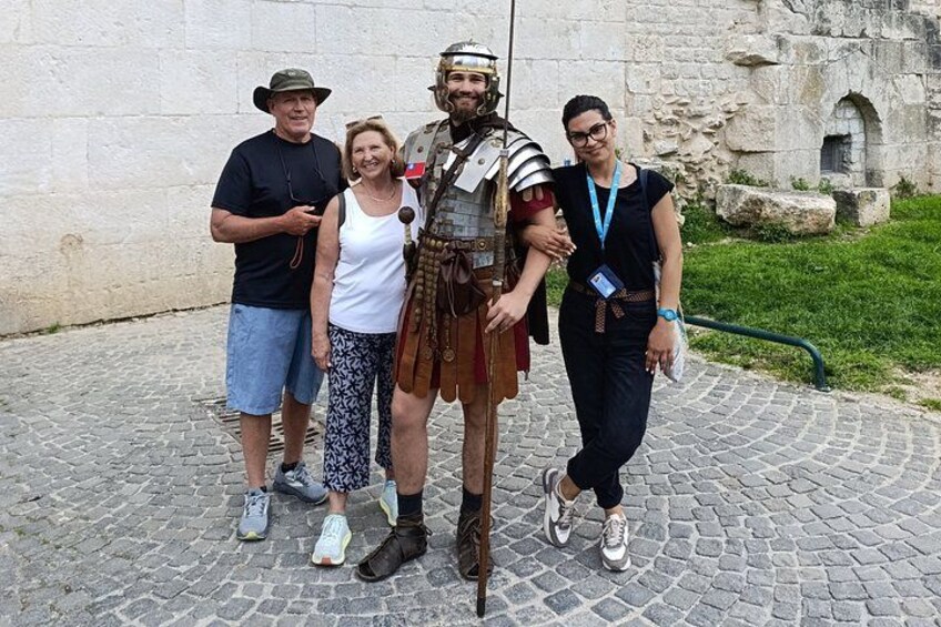 A cobblestone path, a stone wall, and a person in historical costume. 3