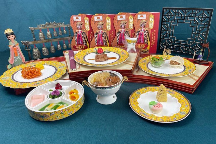 A traditional Chinese tea set with teapots, cups, and a decorative tray. 4