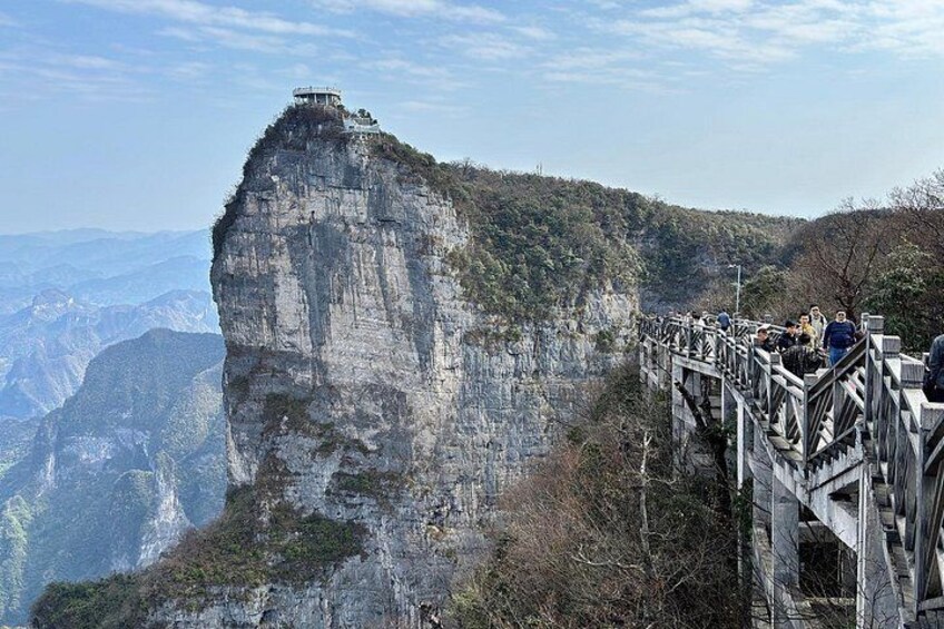 A rock formation with a viewing platform and a bridge. 3