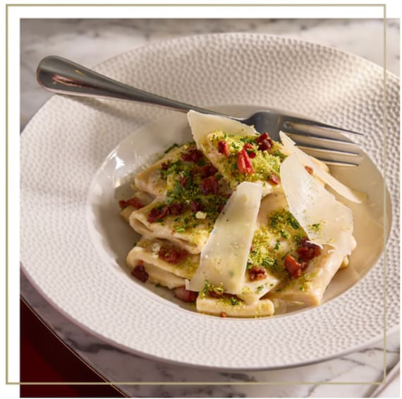 A plate of ravioli with cheese and herbs. 5