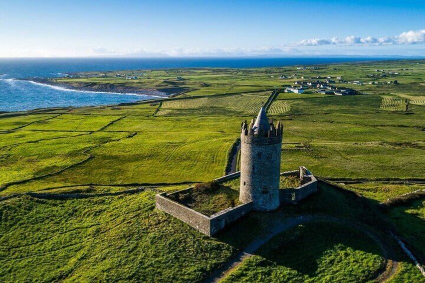 A coastal landscape with a prominent tower and fields. 3