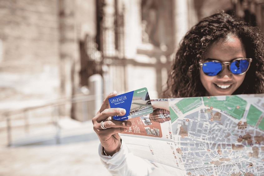 A person holding a tourist card and a map. 3