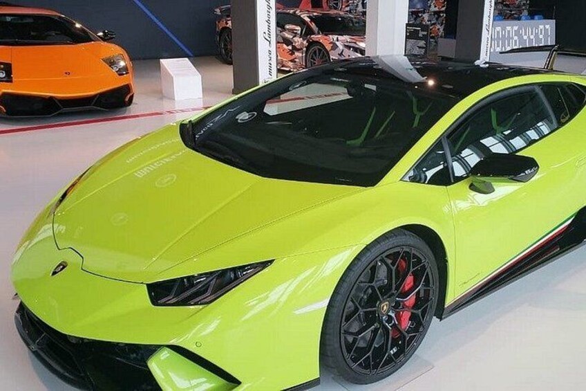 A bright yellow sports car with black rims and a black roof. 2
