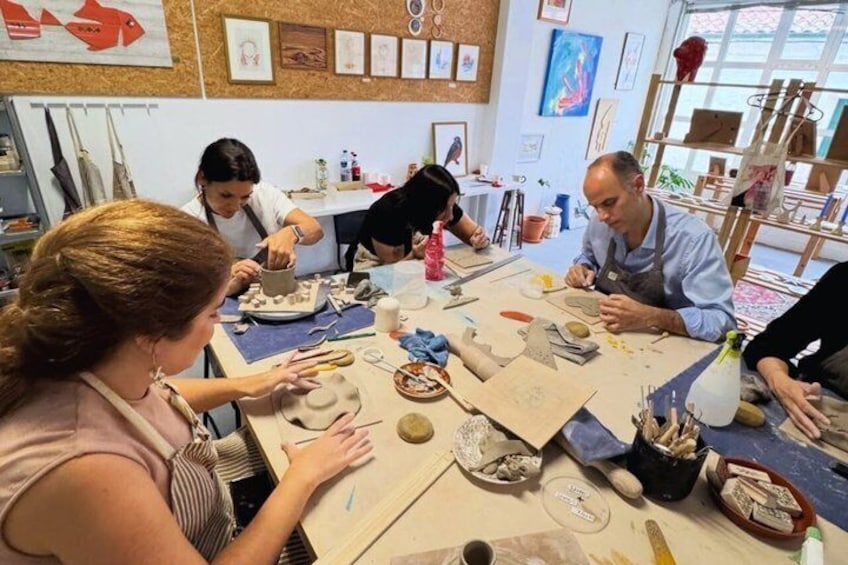 A pottery workshop with participants engaged in crafting pottery. 1