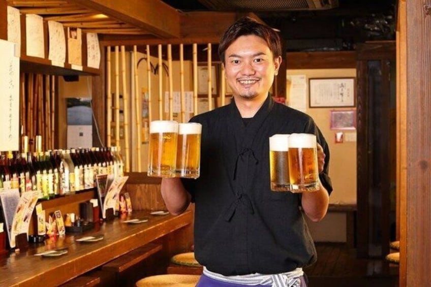 A person holding two beer mugs at a bar with a wooden interior and a variety of bottles on the shelves. 3