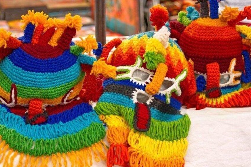 A collection of colorful, crocheted hats with various patterns and designs. 1