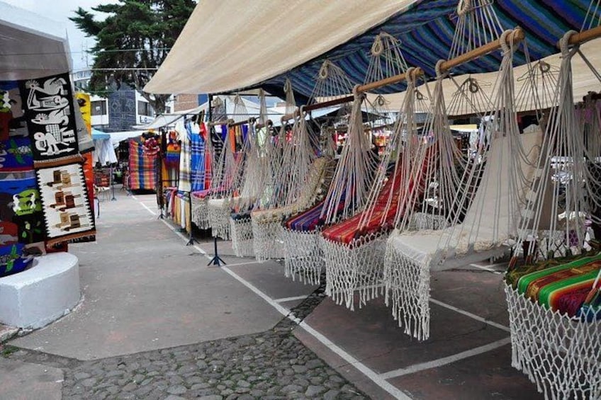 A market with hammocks and colorful textiles. 5
