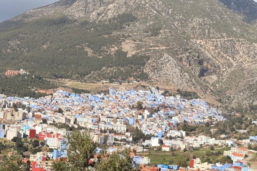 A town with colorful buildings nestled in a mountainous area. 3