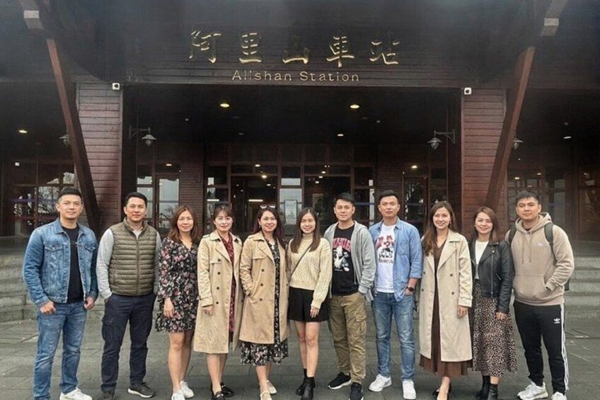 A group of people standing in front of Allshan Station. 3