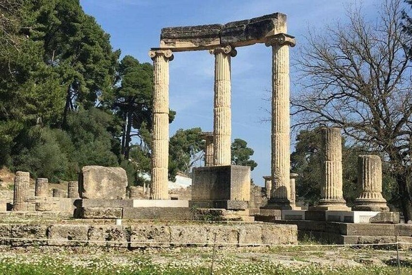 Ancient stone columns and ruins in a historical site. 4