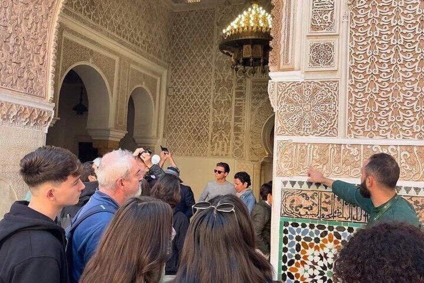 A crowd of people in a historic building with intricate architectural details. 3
