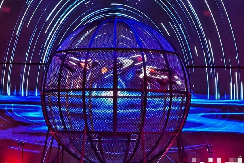A spherical structure with a grid pattern, surrounded by dynamic light trails. 1