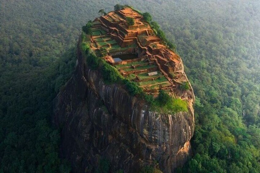 A terraced structure on a steep cliff surrounded by dense forest. 4